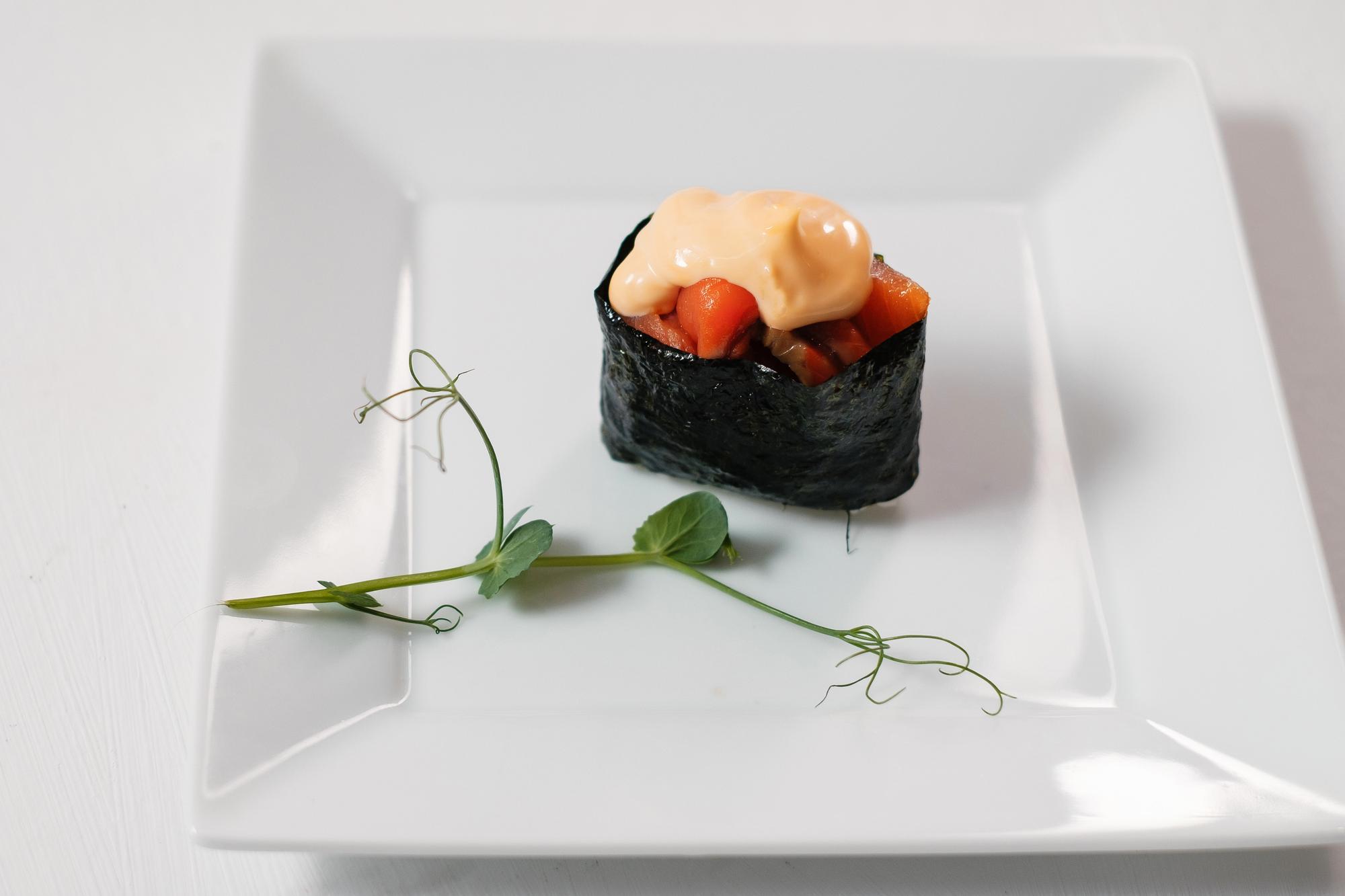 Large editorial shot of plated menu course on slate