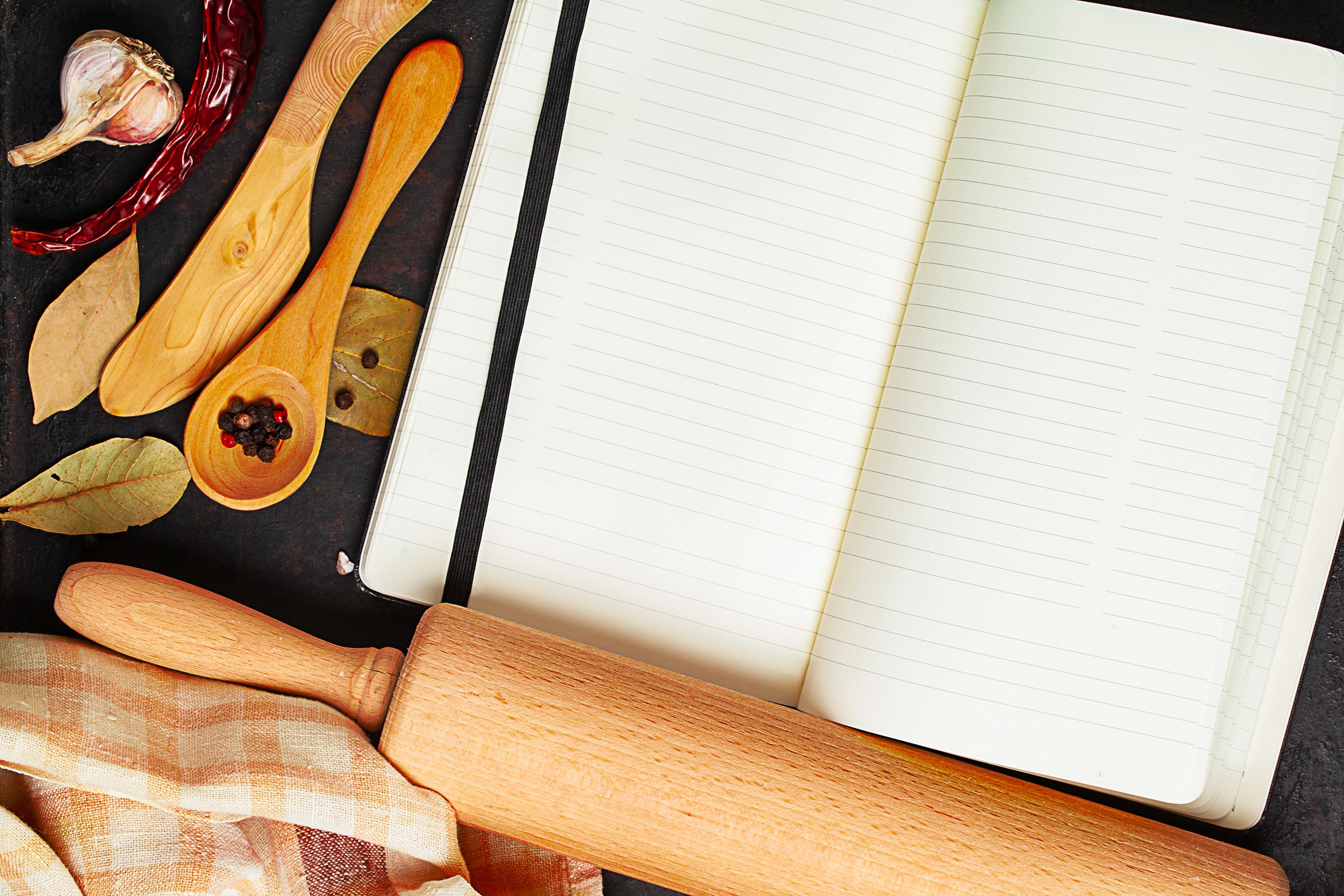 Flat lay of recipe notebook and utensils